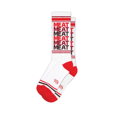 White crew socks with a repeating 'MEAT' pattern in red and brown. Red and brown stripes at the cuff and heel.