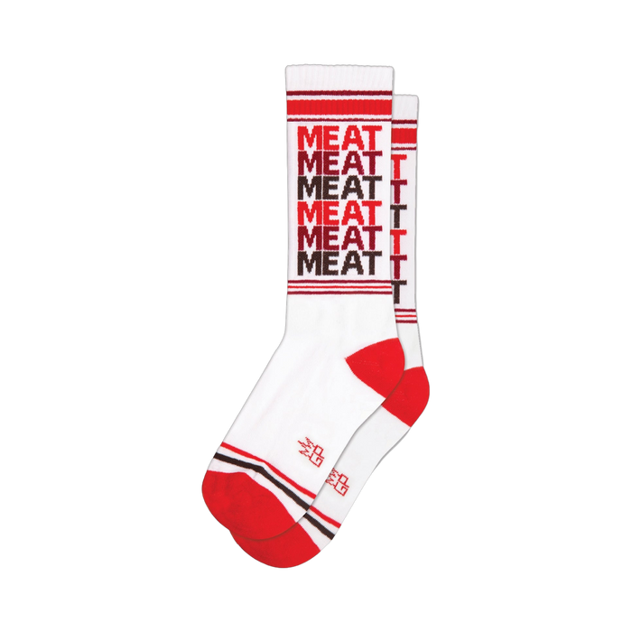 White crew socks with a repeating 'MEAT' pattern in red and brown. Red and brown stripes at the cuff and heel.