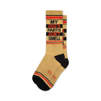 A pair of tan crew socks with black and orange stripes and the text 'MY DOG'S FARTS DON'T SMELL' in black.