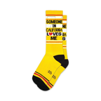 Pair of yellow crew socks with black and red stripes and the text 'Someone in California Loves Me'.
