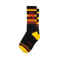 A pair of black crew socks with yellow and red stripes. The socks feature the text 'Eat Drink & Be Moody' in red.