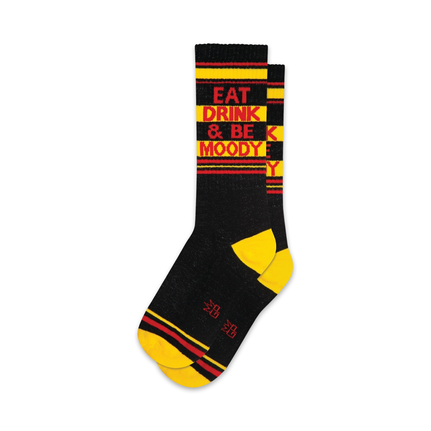A pair of black crew socks with yellow and red stripes. The socks feature the text 'Eat Drink & Be Moody' in red.