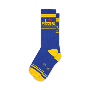 blue puzzle-themed striped crew socks with yellow heels and the words "i love puzzles" written vertically on the front.  