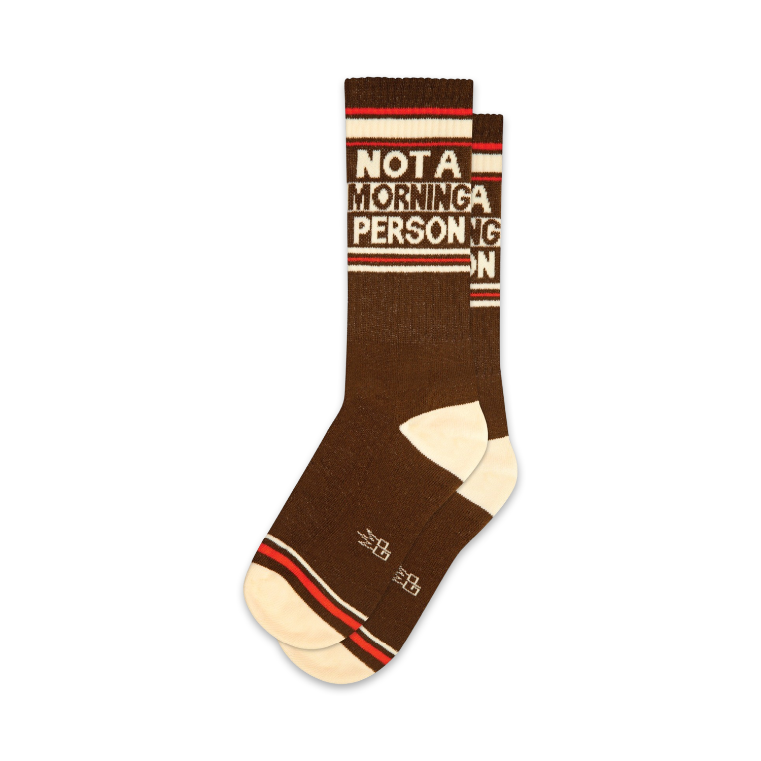 Pair of brown crew socks with off-white and red stripes. Text reads 'NOT A MORNING PERSON' in a retro font.