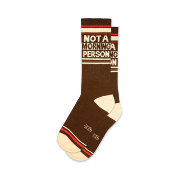 brown crew socks with white toes, heels, cuffs, and red stripes. words "not a morning person" written vertically. for men and women.  