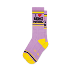 Pair of lavender crew socks with a yellow cuff and heel. The socks feature a graphic that reads 'I love being weird' in black text with a red heart.