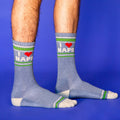 Lifestyle shot of a person wearing the 'I Love Naps' crew socks against a blue background.