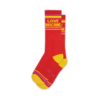 Pair of red crew socks with yellow and purple stripes and 'LOVE MACHINE' in yellow text.