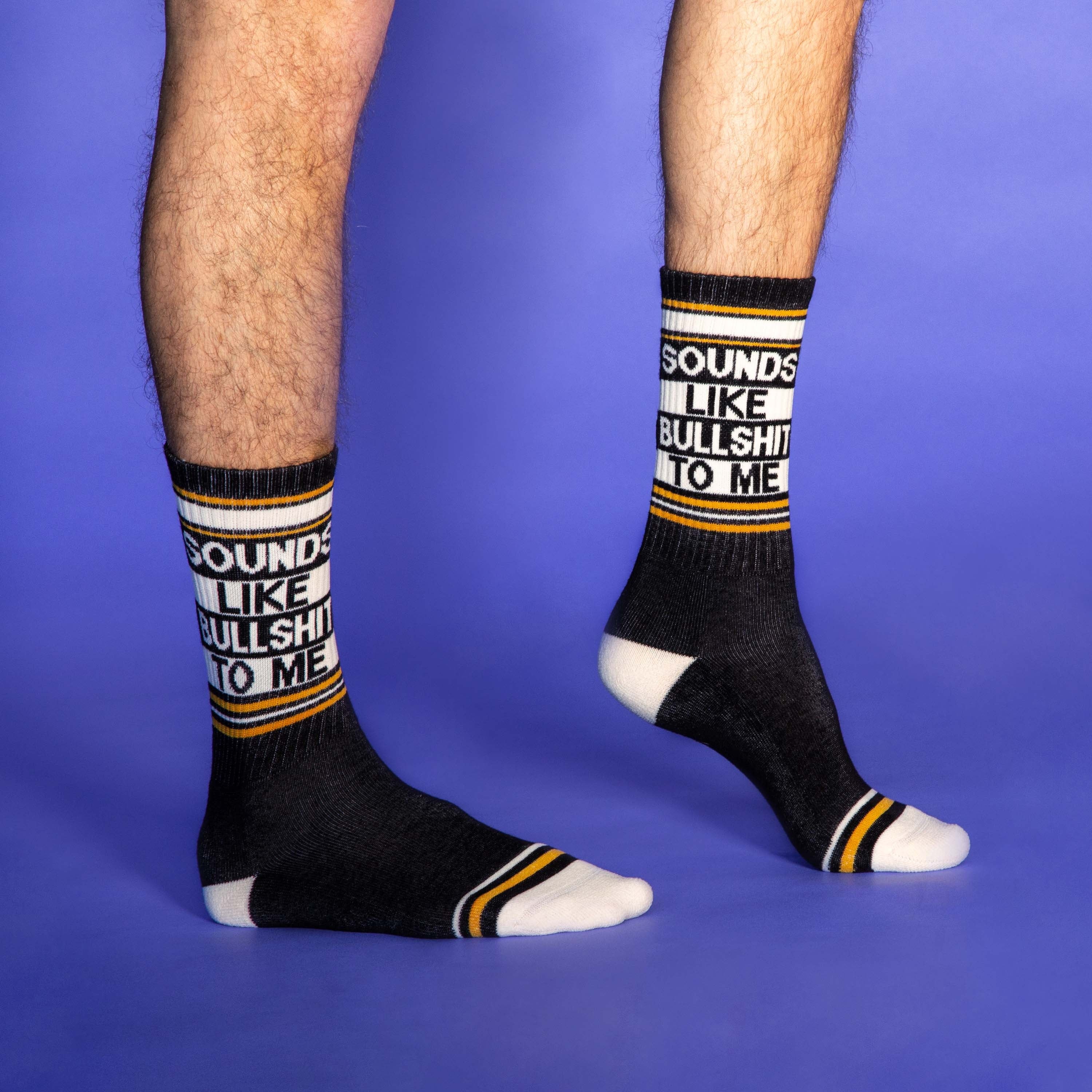 Another lifestyle shot of the socks on a person's legs, this time slightly different pose and angle on purple background. [lf]
