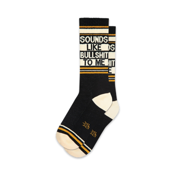 black crew socks for men and women feature white toes and heels, yellow stripe with sounds like bullshit to me text.   