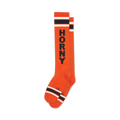 Pair of orange knee-high socks with bold black 'HORNY' lettering and black-and-white stripes at the top and bottom.