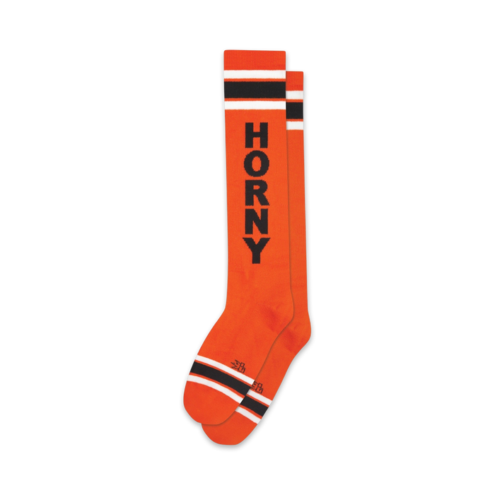 knee-high socks in bright orange with black and white stripes and 'horny' printed boldly across them.  