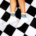 Pair of 'Love' socks on a black and white checkered floor. [lf]