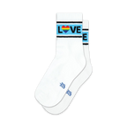 Pair of white crew socks with a light blue, black, and rainbow heart 'LOVE' stripe.