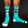 Lifestyle shot: Person wearing teal 'Clean Feet Dirty Mind' crew socks, showcasing the fit and style. [lf]