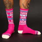 Lifestyle shot: Person wearing the pink 'Cats Don't Give A Fuck' crew socks. Shows the socks on the legs and the fit. [lf]