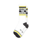 Pair of white crew socks with black and yellow stripes and the text 'Respect The Locals'.