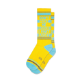A pair of yellow crew socks with teal accents. The socks feature the text 'Don't Make Me Laugh I Fart Easily' in a vertical design.