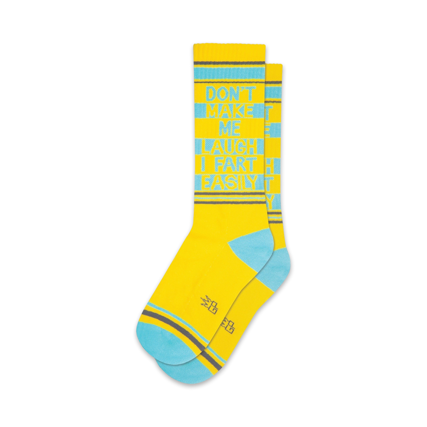 A pair of yellow crew socks with teal accents. The socks feature the text 'Don't Make Me Laugh I Fart Easily' in a vertical design.