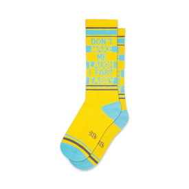 crew length socks in yellow with blue toes, heels, and cuffs feature funny text "don't make me laugh...i fart easily."  