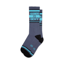 sober grey socks with blue lettering on the leg that says "sober is sexy"; black heel and toe, two thin blue stripes around the top.  