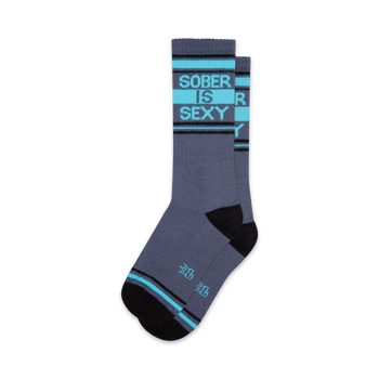 sober grey socks with blue lettering on the leg that says "sober is sexy"; black heel and toe, two thin blue stripes around the top.  