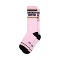 Two pink crew socks with black 'Birthday Bitch' lettering and gold stripes. Black and gold accents at the cuffs.
