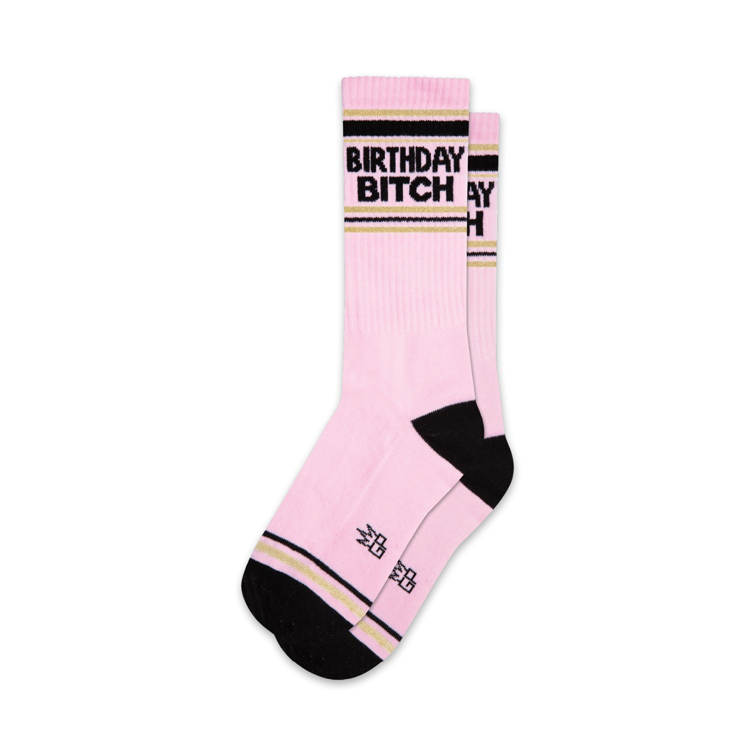 Two pink crew socks with black 'Birthday Bitch' lettering and gold stripes. Black and gold accents at the cuffs.