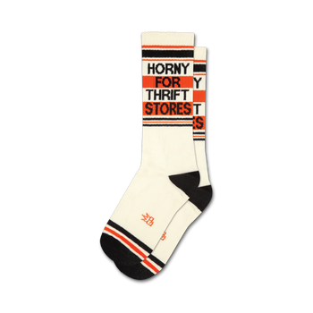 whimsical crew socks with "horny for thrift stores" lettering for men and women, in white with black and orange stripes. 