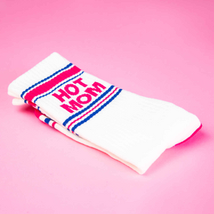 Close-up detail shot of a folded 'Hot Mom' sock, showcasing the fabric and design elements on a pink background.