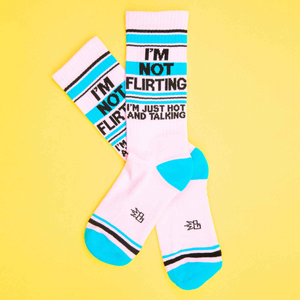 A pair of pink socks with blue stripes and the words 