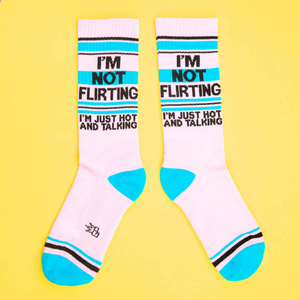 A pair of pink socks with blue stripes and the words 