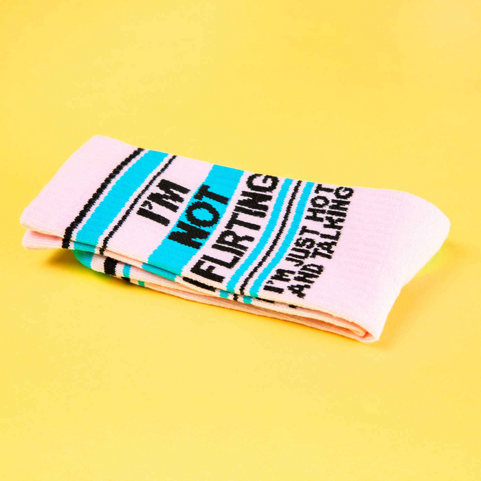 A pair of pink socks with blue stripes and the words 