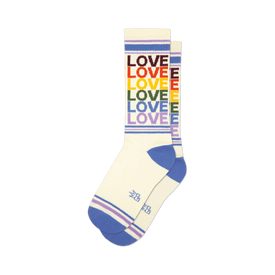 front view of a pair of white socks with rainbow colored "love" repeated down the leg.