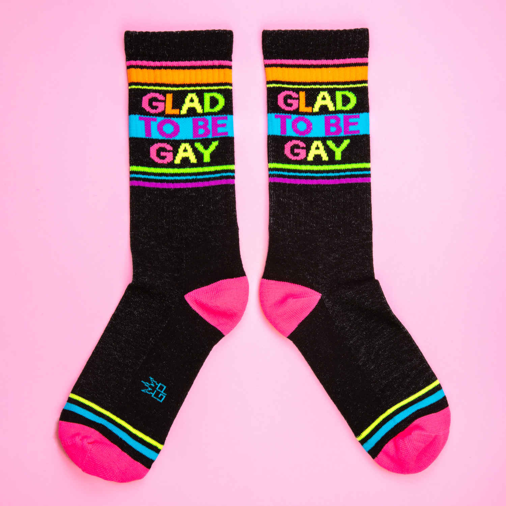Another flat lay showcasing the socks' design and vibrant colors against a pink backdrop.