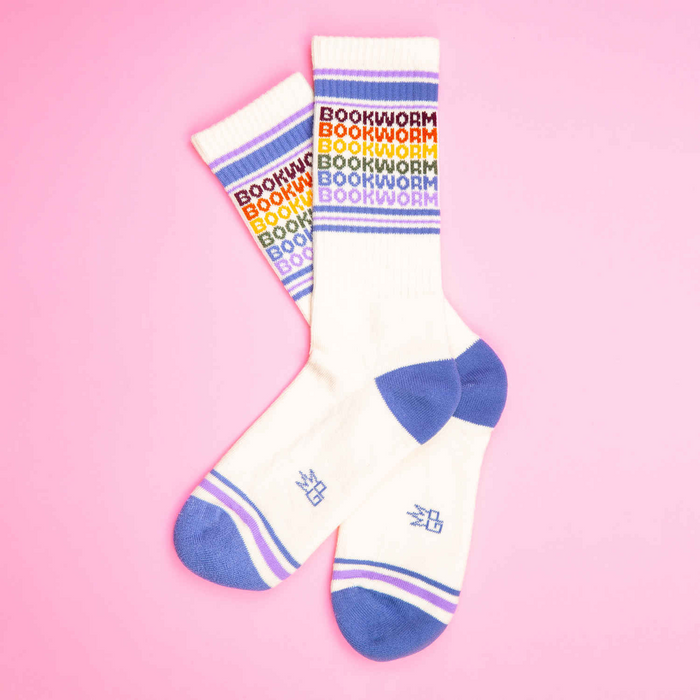 Flat lay product shot of Bookworm socks on a pink background.