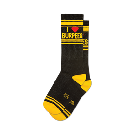 a pair of black socks with the text 'i heart burpees' on the leg in yellow and red. the socks have yellow toes, heels, and cuffs.