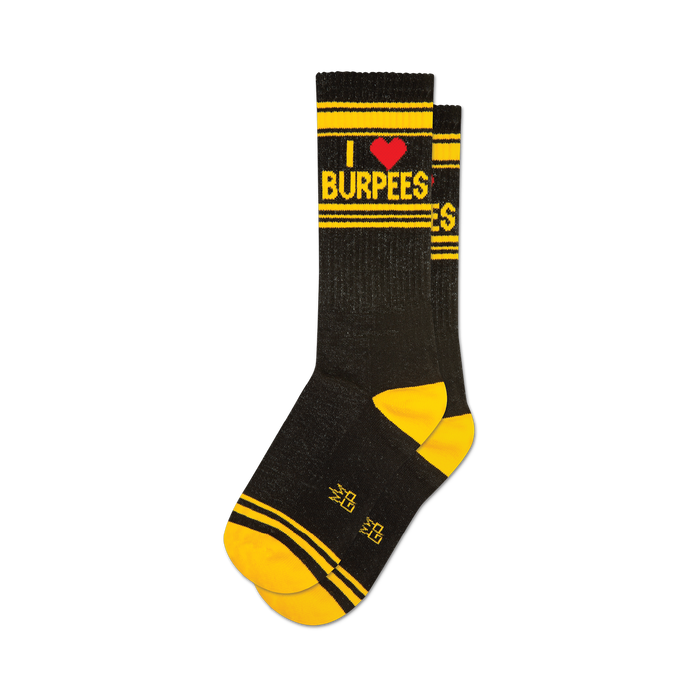 a pair of black socks with the text 'i heart burpees' on the leg in yellow and red. the socks have yellow toes, heels, and cuffs. }}