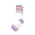 Pair of white crew socks with lavender heel and toe. Blue, orange, and lavender stripes accent the white background with the text 'My Dog Is My Therapist'.