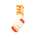 Pair of white crew socks with orange and yellow stripes and the text 'I heart Mac and Cheese'.