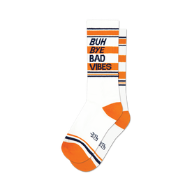 socks that are white with orange and blue stripes at the top and orange heels and toes. 'buh bye bad vibes' is written on the front of the socks in blue with an orange shadow.