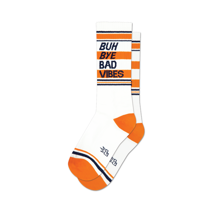 socks that are white with orange and blue stripes at the top and orange heels and toes. 'buh bye bad vibes' is written on the front of the socks in blue with an orange shadow. }}