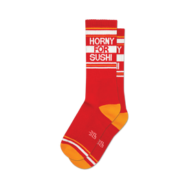 socks that are red with white and orange stripes at the top and orange heels and toes. the words 'horny for sushi' are knitted into the front of the socks in white.