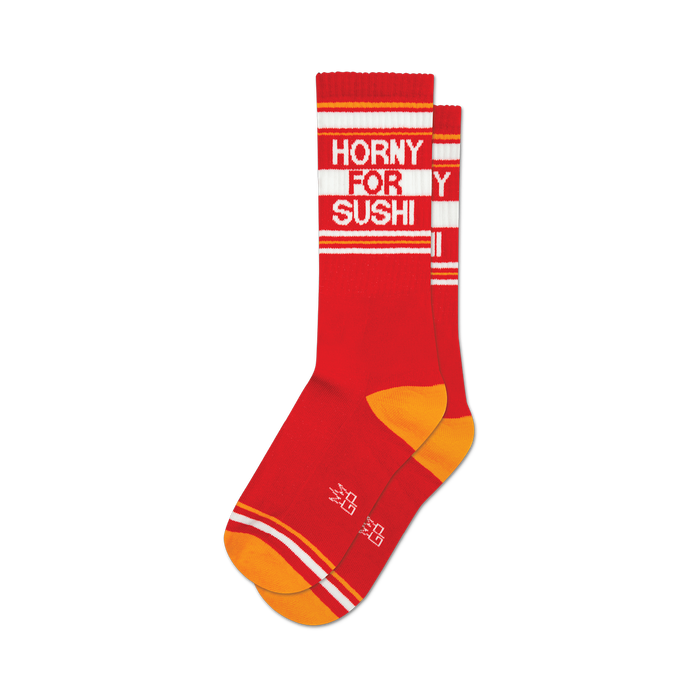 socks that are red with white and orange stripes at the top and orange heels and toes. the words 'horny for sushi' are knitted into the front of the socks in white. }}