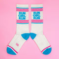 Another flatlay of 'Run Girl Run' socks on pink; socks are arranged to showcase the design better. [lf]