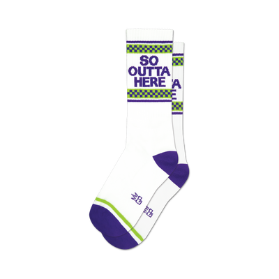 socks that are white with purple toes, heels, and cuffs. there is a green and white checkered pattern above the purple cuff. the words 'so outta here' are printed in purple block letters on the front of the socks.