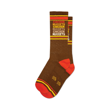 socks that are brown with red and orange stripes at the top and bottom. the word 'chicken nuggets' is repeated vertically in orange and yellow text.