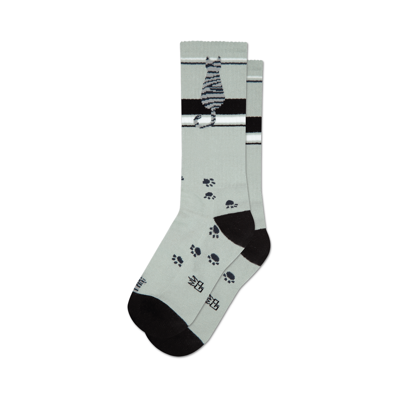 A pair of crew socks in light gray with a sitting gray tabby cat, black stripes, and scattered black paw prints.