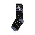 Pair of black crew socks with a grey stripe featuring upside-down white cats and scattered white paw prints. 