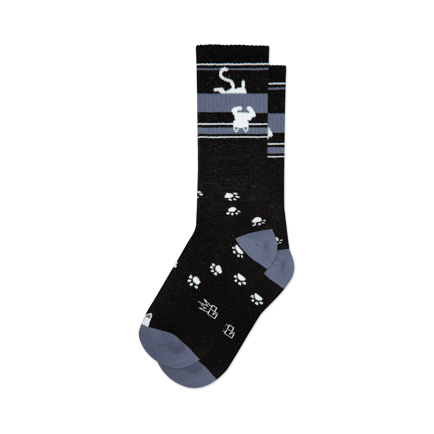Pair of black crew socks with a grey stripe featuring upside-down white cats and scattered white paw prints. 